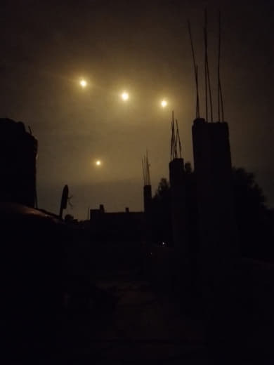 Lighting bombs form a condenser east of the city of Beit Hanoun