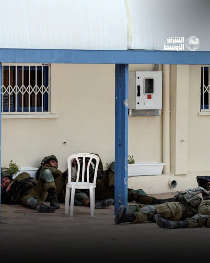 Israeli soldiers sleep in the street near a police station seized by Palestinian fighters in the city of Sderot yesterda