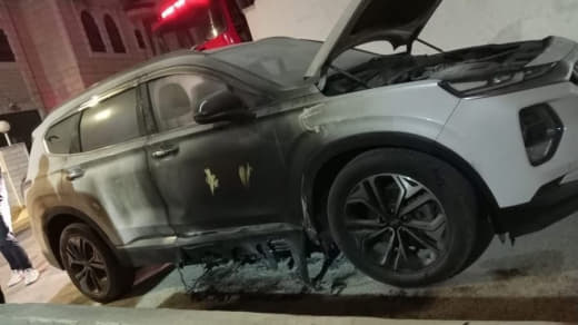 Settler groups burn two vehicles and write hostile Hebrew slogans during an attack on the town of Taybeh, east of Ramall