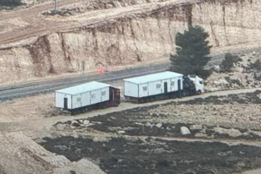 Settlers prepare new rooms to expand the “Ramat Magron” outpost on the lands of the towns of Barqa and Deir Dibwan, east