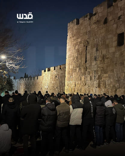 Palestinians perform Taraweeh prayers near Bab al-Asbat in occupied Jerusalem, as Israeli authorities continue to keep A
