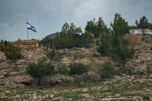 Israeli settlers set up a mobile housing unit in the Wadi Tayasir area, northeast of Tubas, raising Israeli flags as par