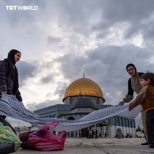 A Palestinian family breaks iftar at the Al-Aqsa Mosque compound in occupied East Jerusalem during the holy month of Ram