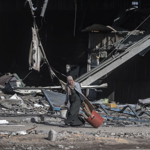 A Palestinian woman collects wood to use for heating and preparing food in Al-Maghazi camp in the central Gaza Strip.