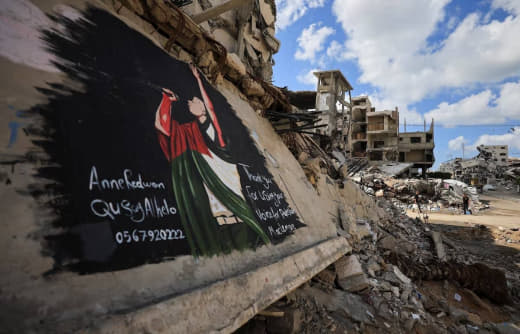 Artists in Gaza have painted a mural depicting US rapper Macklemore wrapped in a Palestinian flag on a massive slab of c