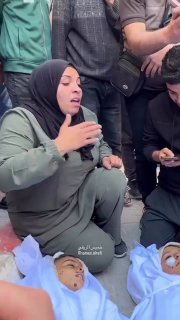 A mother bids farewell to her two children who were killed in an Israeli air strike that targeted a group of civilians i
