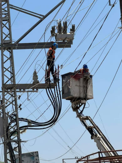 Electricity company crews are working to connect wires to one of the generators in Al-Balah in the central Gaza Strip