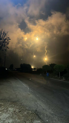 Media coverage: "The occupying Israeli regime fires flares over southern Lebanon."