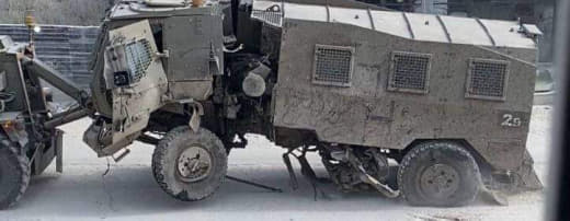 The Israeli occupation army pulls out an armored personnel carrier after being significantly damaged during confrontatio